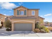 Two-story house with gray garage door and landscaping at 8322 Rygate Ave, Las Vegas, NV 89178