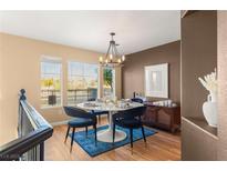 Bright dining room features a modern chandelier and seating for four at 8437 Sluman Ct, Las Vegas, NV 89128