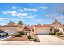 Inviting single-story townhome featuring a well-manicured yard and attached one-car garage, under a blue cloudy sky at 8617 Prairie Hill Dr, Las Vegas, NV 89134