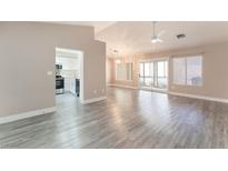 Bright, open living room with hardwood floors and views of the adjacent kitchen at 8617 Prairie Hill Dr, Las Vegas, NV 89134