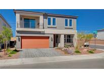 Two-story house with orange garage door and landscaped yard at 8749 Black Cordon Rd, Las Vegas, NV 89139