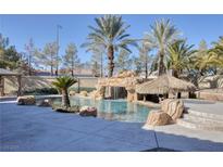 Resort-style pool with waterfall and tiki bar at 9113 Harvest Homes St, Las Vegas, NV 89123