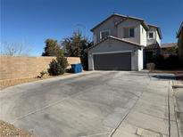 Two-story house with gray garage door and landscaped yard at 10106 June Flower Dr, Las Vegas, NV 89141
