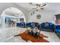 Spacious living room with marble floors and stylish blue velvet furniture at 1431 Di Blasi Dr # 105, Las Vegas, NV 89119