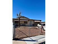 Ranch-style house with a front yard, driveway, and striped awnings at 3501 Orvis St, North Las Vegas, NV 89030