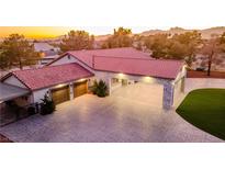 Beautiful home featuring a red tile roof, paved driveway, and covered carport with exterior lighting at 5353 Dorrell Ln, Las Vegas, NV 89131