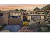 Tan two-story home with balcony and desert landscaping at 536 Woodcrest Dr, Boulder City, NV 89005