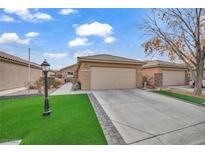Single-story house with a two-car garage and landscaped front yard at 5697 Crowbush Cove Pl, Las Vegas, NV 89122