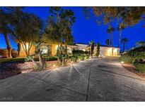 Elegant single-story home with landscaped yard and a long driveway at 7015 N Jensen St, Las Vegas, NV 89149