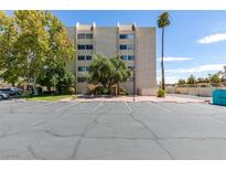 Condo building exterior with parking and landscaping at 730 S Royal Crest Cir # 414, Las Vegas, NV 89169