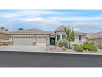 Charming single-story home featuring a three-car garage and desert landscaping at 8216 Wooden Windmill Ct, Las Vegas, NV 89131