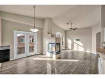 Bright living room features a fireplace and access to a private balcony at 8780 Horizon Wind Ave # 101, Las Vegas, NV 89178