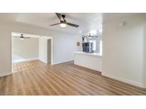 Bright living room with hardwood floors and ceiling fan at 1408 Palm St, Henderson, NV 89011