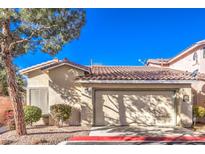 Tan stucco house with a two-car garage and desert landscaping at 1473 Teddington Ct # 101, Las Vegas, NV 89102