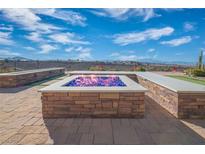 Relaxing backyard fire pit with seating and mountain views at 1645 Warrington Dr, Henderson, NV 89052