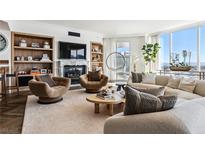 Spacious living room with hardwood floors, fireplace, and city views at 2857 Paradise Rd # 2203, Las Vegas, NV 89109