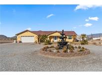 Single-story home with a fountain and landscaped yard at 3720 W Charleston Park Ave, Pahrump, NV 89048