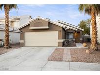 Single-story house with a two-car garage and landscaped front yard at 7336 Young Doe Ave, Las Vegas, NV 89130