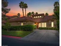 Inviting single story home with mature trees, well-manicured hedges, and a red tile roof, showcasing curb appeal at 8199 Pinnacle Peak Ave, Las Vegas, NV 89113