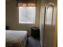 Cozy bedroom with nightstands and window coverings at 9016 Gabro Ln, Las Vegas, NV 89123