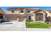 Two-story house with a three-car garage and landscaped lawn at 1559 Via Della Scala, Henderson, NV 89052
