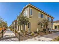 Tan two-story townhome with walkway and landscaping at 20 Barbara Ln # 35, Las Vegas, NV 89183