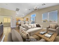 Spacious living room with hardwood floors and access to balcony at 5536 Valensole Ave, Las Vegas, NV 89141