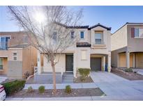 Two-story house with gray siding, attached garage, and small front yard at 9009 Careful Canvas Ave, Las Vegas, NV 89149