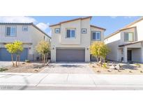 Two-story house with gray garage door and landscaped yard at 10009 Cabernet Hills St, Las Vegas, NV 89141