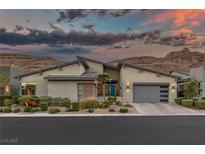 Modern home with gray siding, teal door, and landscaped yard at 10271 Meridian Hill Ave, Las Vegas, NV 89135