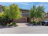 Beautiful two-story home with a well-manicured lawn and a two-car garage at 10273 Aragon Crown Rd, Las Vegas, NV 89135