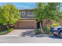 Charming two-story home with a brick driveway, two-car garage and mature landscaping at 10273 Aragon Crown Rd, Las Vegas, NV 89135