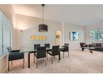 Bright dining room with glass table and black chairs at 10800 Heritage Hills Dr, Las Vegas, NV 89134