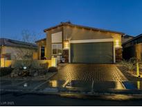 Attractive single-story home with a landscaped front yard and two-car garage at 1297 Paseo Del Oso Ln, Henderson, NV 89002