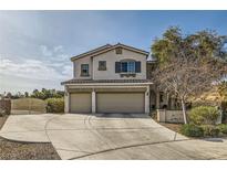 Two-story house with three-car garage and landscaped yard at 1738 Sonoran Bluff Ave, Henderson, NV 89014