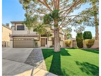 Two-story house with a landscaped yard, large tree, and a two-car garage at 3655 Funston Way, Las Vegas, NV 89129