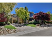 Beautiful home with a circular driveway, mature landscaping, and a well-maintained front yard at 4450 Palisades Canyon Cir, Las Vegas, NV 89129