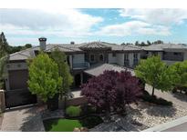 Stunning single-Gathering home with a well-manicured yard and mature trees under a bright sky at 4450 Palisades Canyon Cir, Las Vegas, NV 89129