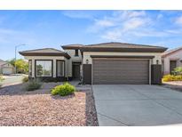 Single-story home with a two-car garage and desert landscaping at 511 Dalgreen Pl, Henderson, NV 89012