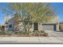 Single-story home with modern facade, landscaped yard, and attached garage at 6834 Compass St, North Las Vegas, NV 89084