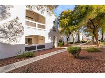 Exterior view of condo building with walkway and landscaping at 700 Carnegie St # 2914, Henderson, NV 89052