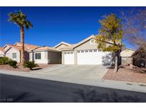 Single-story house with two-car garage, landscaping, and desert landscaping at 8772 Rio Grande Falls Ave, Las Vegas, NV 89178