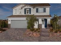 Two-story house with gray siding, brown roof, and landscaped front yard at 9190 Oakdale Ranch Ct, Las Vegas, NV 89139