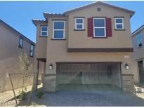 Inviting two-story home with red shutters, a two-car garage, and desert landscaping at 10039 Sir Atlas Ct, Las Vegas, NV 89148