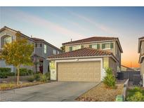 Charming two-story home featuring a two-car garage and desert landscaping at 1129 Majestic Canyon St, Henderson, NV 89052