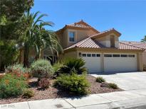 Beautiful two-story home with a three-car garage and desert landscaping at 2908 Channel Bay Dr, Las Vegas, NV 89128