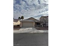 One-story house with attached garage and driveway at 5804 Sassa St, Las Vegas, NV 89130