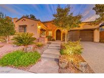 Beautiful home with landscaping, brick accents, and a two-car garage at 59 Portezza Dr, Henderson, NV 89011