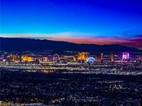 Striking panoramic view of the Las Vegas skyline at dusk, showcasing the city lights and distant mountains at 591 Overlook Rim Dr, Henderson, NV 89012