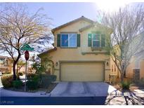 Two-story house with a beige exterior, two-car garage, and landscaping at 7529 Earnshaw Ave, Las Vegas, NV 89149